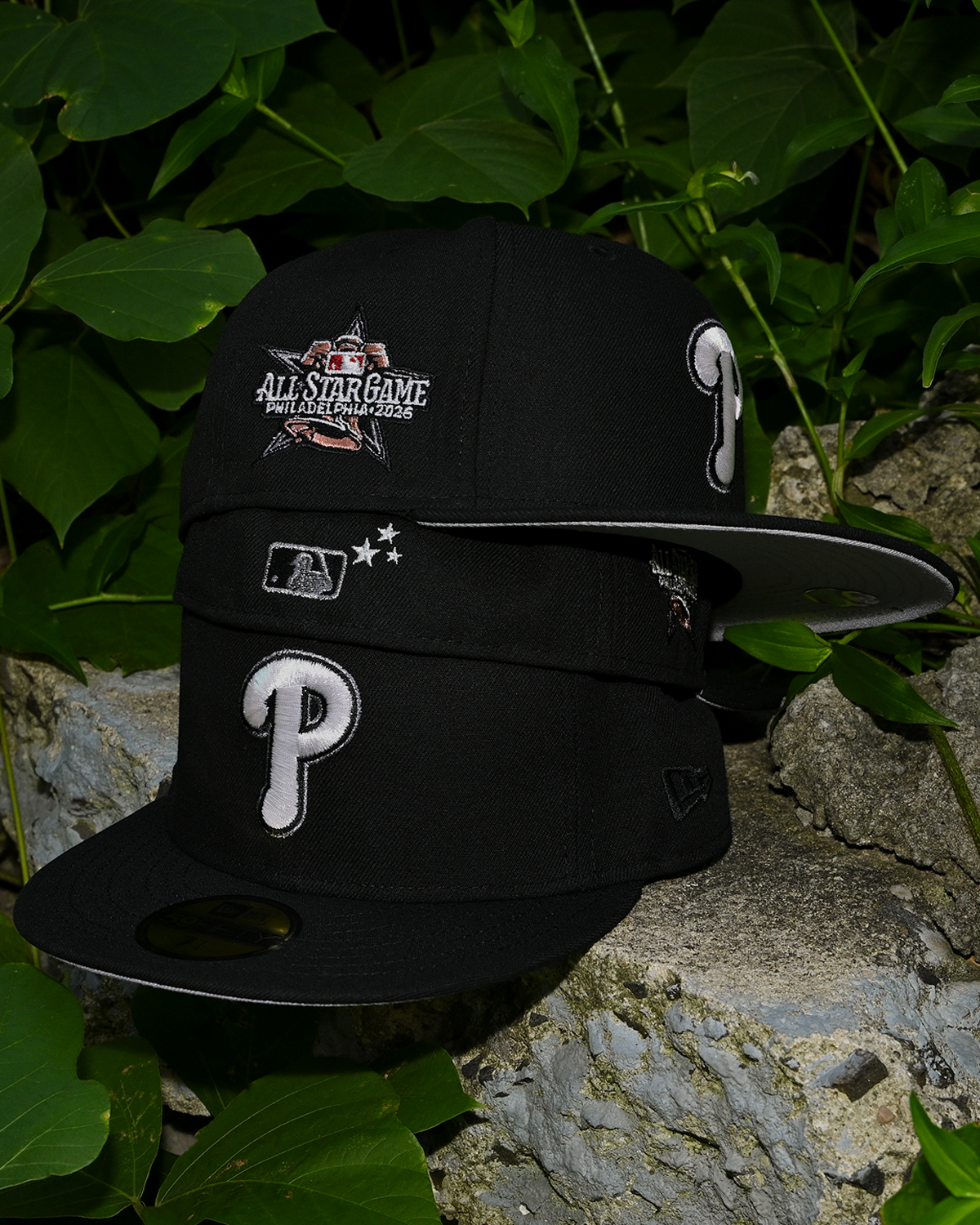 Side view of the Black/Metallic Iris Phillies 59Fifty showing the All Star Game Philadelphia 2026 patch and grey under visor