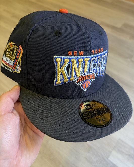 New York Knicks 1998 All Star Weekend 59Fifty, three quarter view of the navy crown with gold and blue Knicks script and the 1998 All Star Weekend side patch