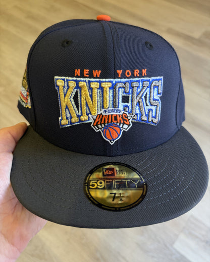 New York Knicks 1998 All Star Weekend 59Fifty, front view of the gold and blue New York Knicks wordmark on a navy crown with an orange button and graphite visor