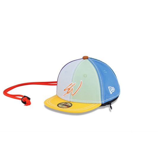 Sean Wotherspoon Mini 59Fifty Earphone Case, three quarter view from the left with the embroidered signature on multicolor panels and the red cord